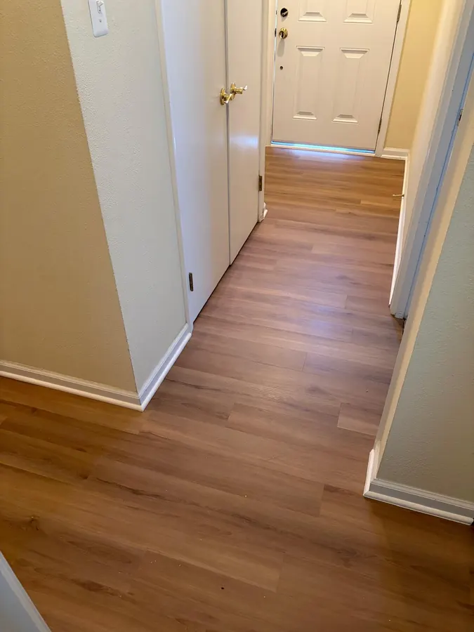 Honey toned LVP running down an entry hallway