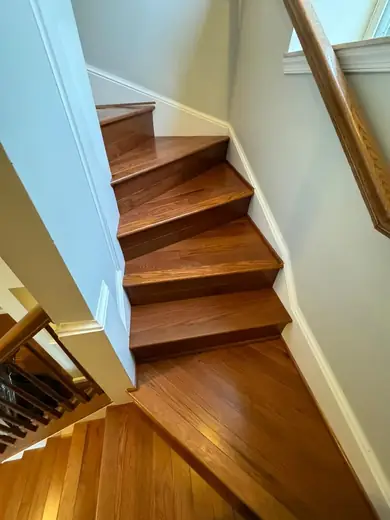 Cherry toned treads turning a corner over white risers