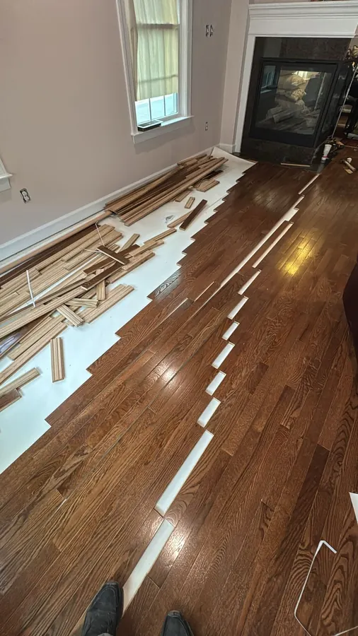 Red oak going down board by board with the offcuts still on the floor